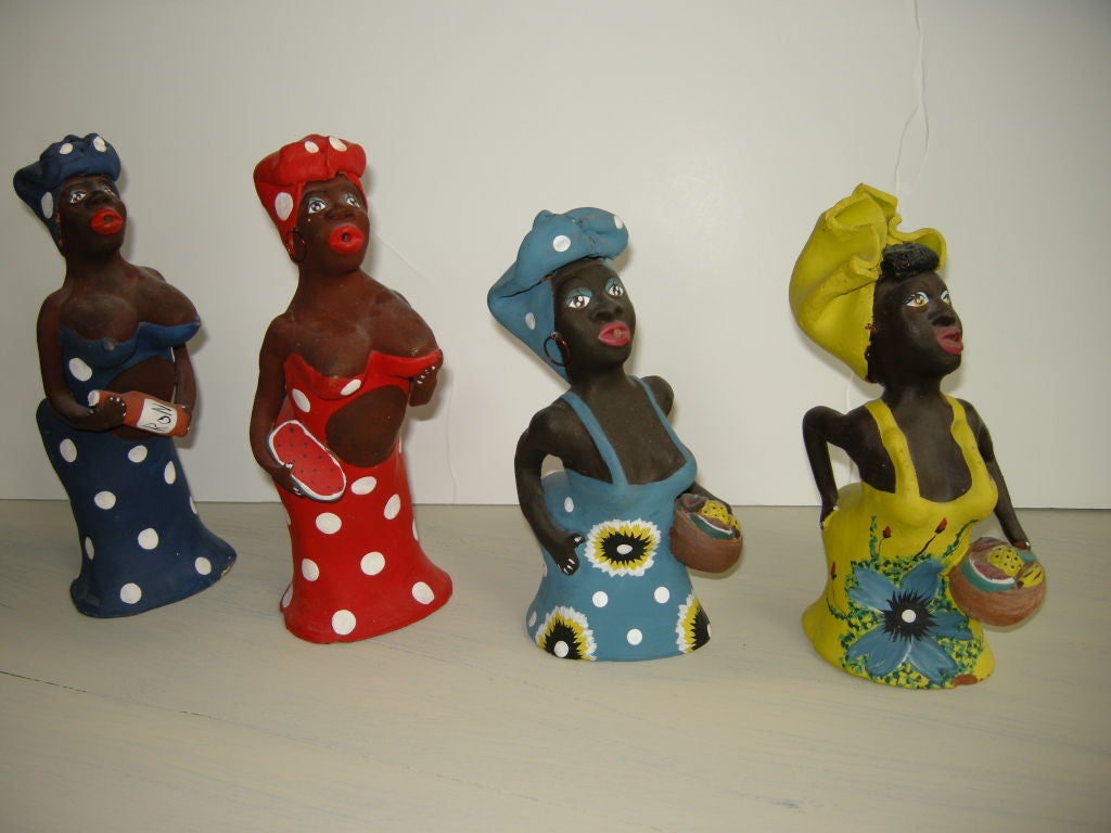 Four exaggerated female ceramic figures (incense burner's) the incense is held in the mouth. The lady in blue is holding a Ron Bacardi Rum bottle,the others are all holding fruit in wooden bowls.Cuba is stamped on there dresses.The measurements