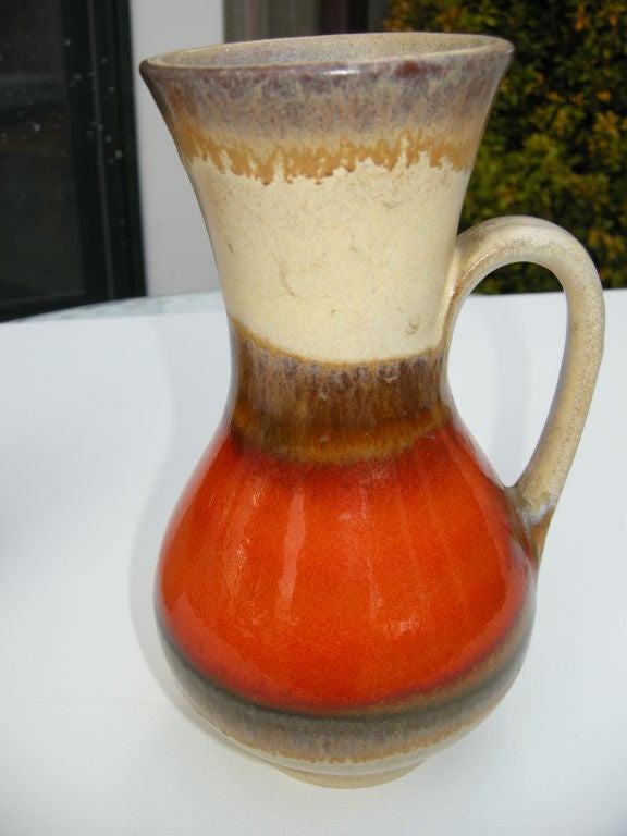 Two colorful Mid-Century studio pottery vases,in  bright rusty orange sand and brown tones,can be purchased seperately,the measurements below are for the larger vase the smaller one measure's H8' D5'. The marks are unclear,but they are probably