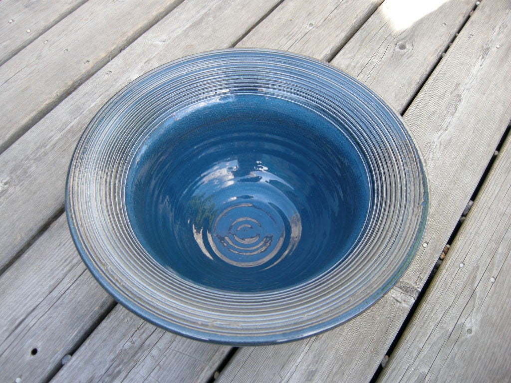 A Welsh cobalt blue ceramic studio pottery bowl, hand thrown and hand brushed in a wonderful high gloss glaze finish. Ribbed relief rim showing through to the bisque (nice touch).