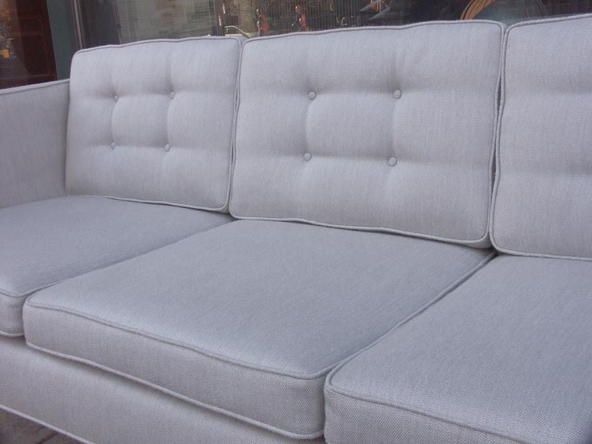 A subtle and simply stunning sofa by Baughman for Thayer Coggin. A clean linear design with a crisp profile. Newly reupholstered in a light gray fabric with a mild hint of sheen.