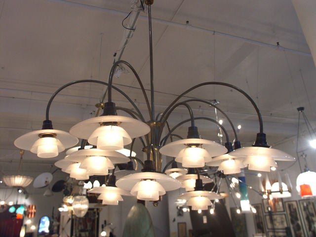 A rare and all original Poul Henningsen 15 branch bombardment chandelier, manufactured by Louis Poulsen, 1940's. An exceptional example of the design, with the original frosted glass shades, and  brass branches in excellent condition. Also including