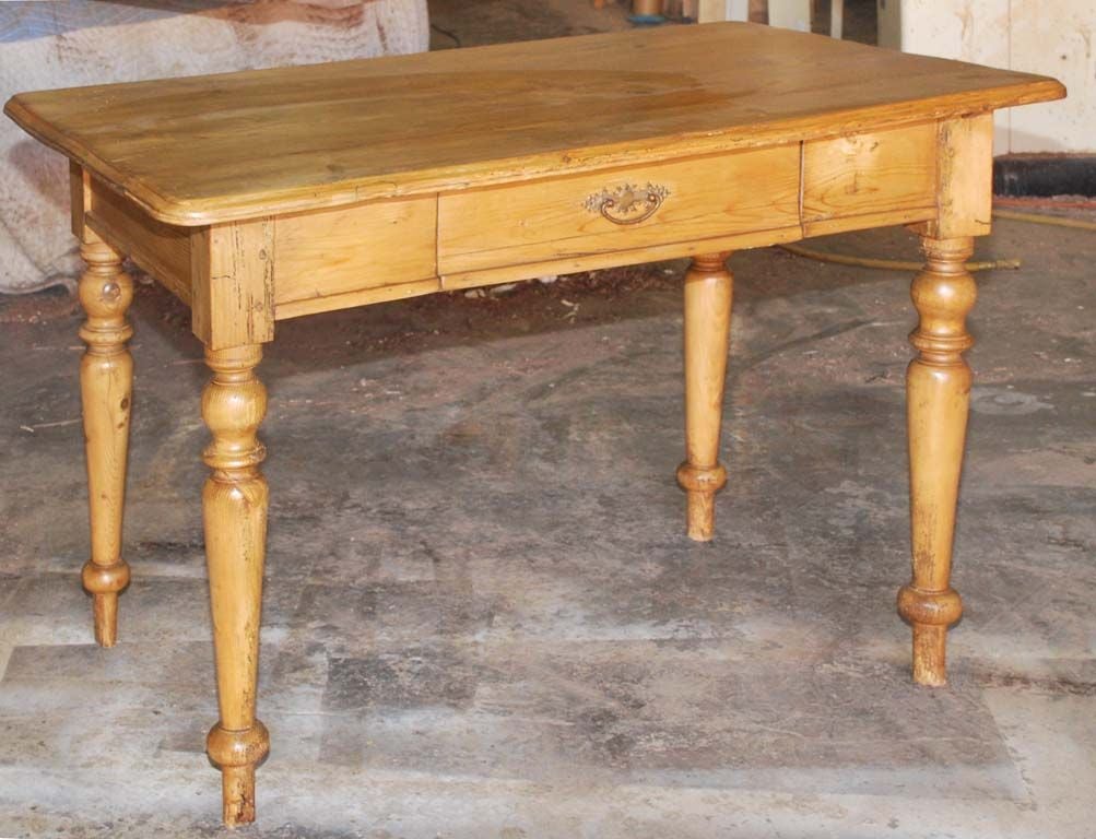 Charming little table with nicely turned legs and a drawer. This table has enough floor clearance so that it can be used as a small desk for a normal sized person. This is rare!