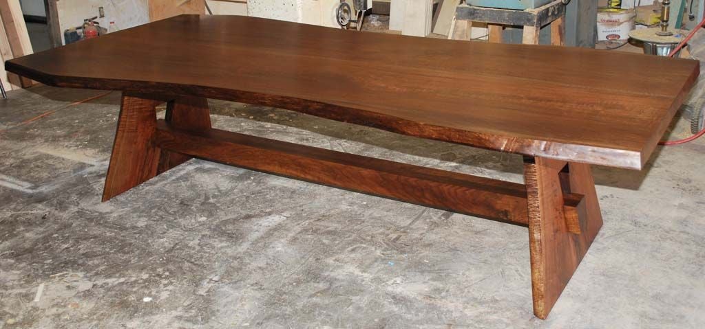 This live edge table is made from two 'sister-slabs' of book-matched black walnut. The top is made from the two center cuts of a massive Pennsylvania black walnut tree trunk. The two slabs were 'butterflied' creating a symmetric grain pattern in the