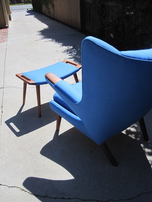 A beautiful all-teak Papa Bear chair upholstered in blue felt with matching ottoman.  This example was reupholstered by Chris Hansen, noted Danish master upholsterer who worked for Wegner in Denmark on his original designs and has since been living