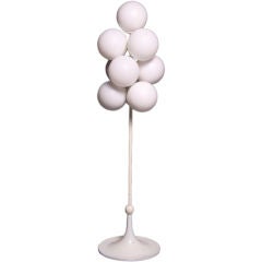 A mid century white globe floor lamp