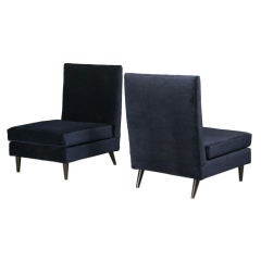 A pair of large scale tall slipper chairs by Joaquim Tenreiro