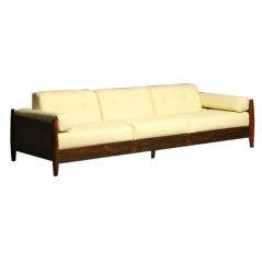 A Rosewood And Cream Leather Sofa