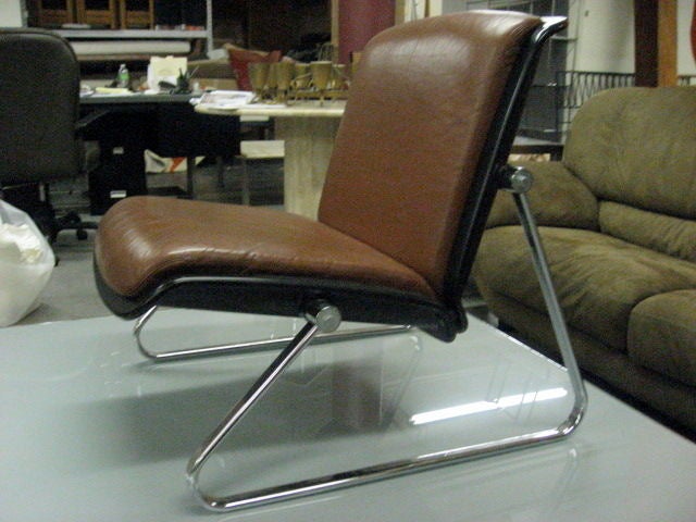 Pair of Chairs in tubular chrome with leather seat and backs and molded plastic frame