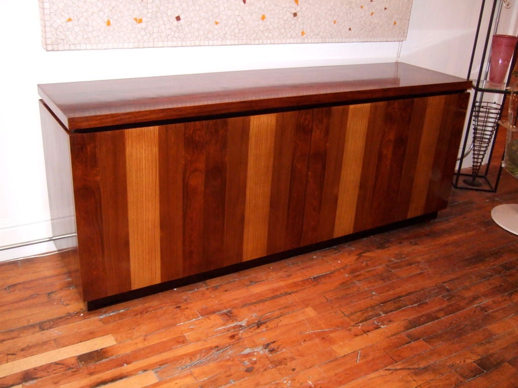 Gorgeous credenza by Milo Baughman for Maurice Villency.  This is a credenza to line up for. Nicely sized for maximum storage but not overwhelming to the room. Rosewood and walnut and other hardwoods show off their colors on the doors of this piece,