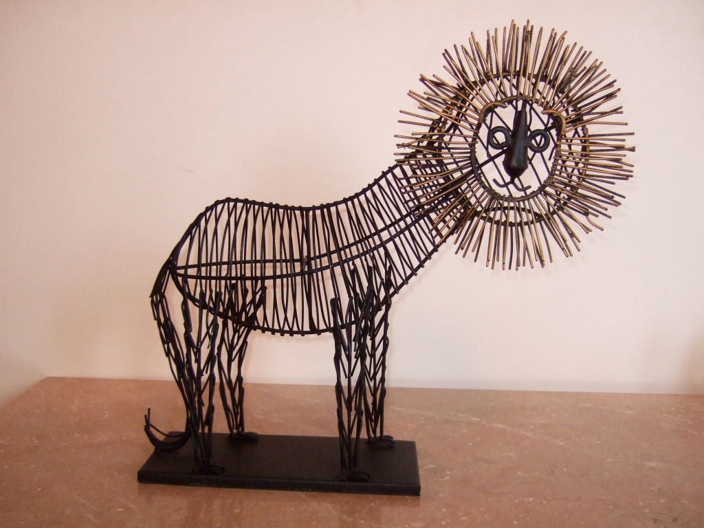 Lion sculpture prowls along in handcrafted wire and brass.  Great attention to detail, with brass mane framing the happy face. Base is made out of metal.<br />
<br />
Please visit our gallery in Stamford, Connecticut located at 583 Pacific Street.