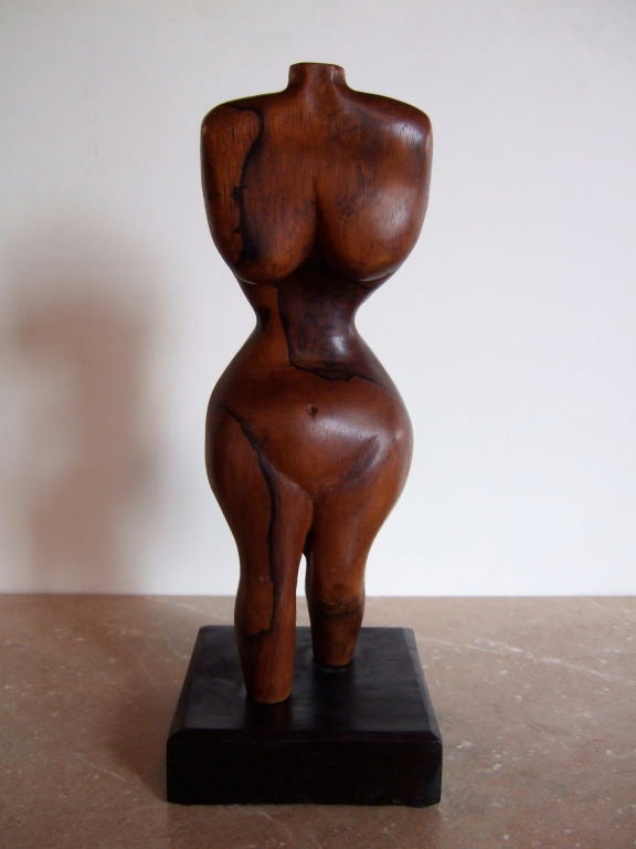 Amazing rosewood sculpture of a woman with an exaggerated pose and abstract proportions. The sculpture is of a woman's torso and legs; it has no feet, arms, or head. The sculpture is made out of a beautiful piece of wood. It sits on a black square