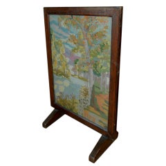 A needlepoint framed fire screen or a tabletop decoration