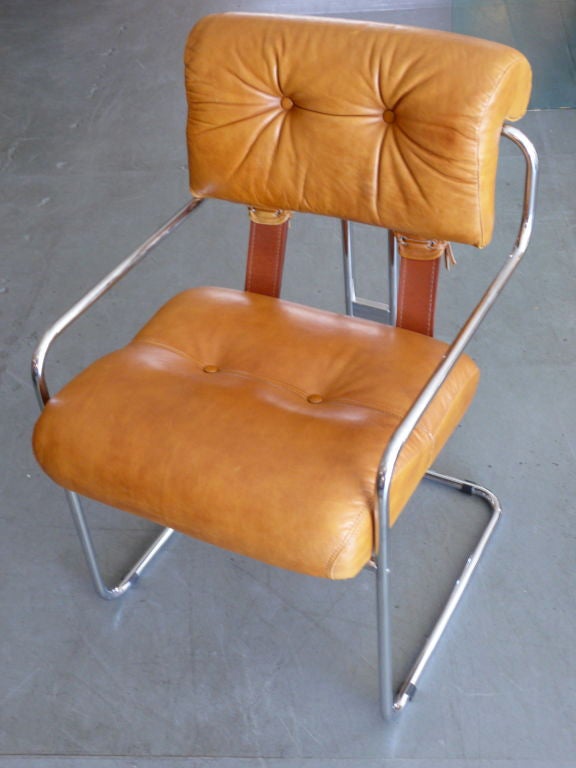 Mariani for Pace Collection dining chairs. Simple tubular chrome base with soft camel brown leather. Fantastic leather corset detailing in the back with leather straps. <br />
7 chairs available and priced individually.