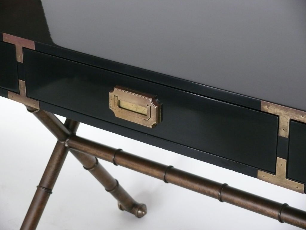 Great campaign desk lacquered in dark navy blue with original antique brass X base with matching hardware.