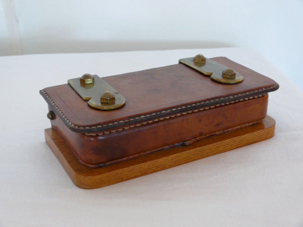 Unique brown leather and wood box with brass detailing. Beautiful patina to leather with contrast stitching and two compartments inside.
