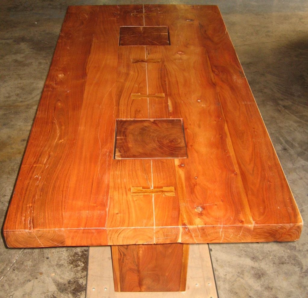 Superb Asian imported dining table of recent manufacture, used in a model home setting, and now available for sale.  Originallly bought at ABC Carpet & Home, this piece is rendered in thick planking, buttressed with butterfly bungs, in effect