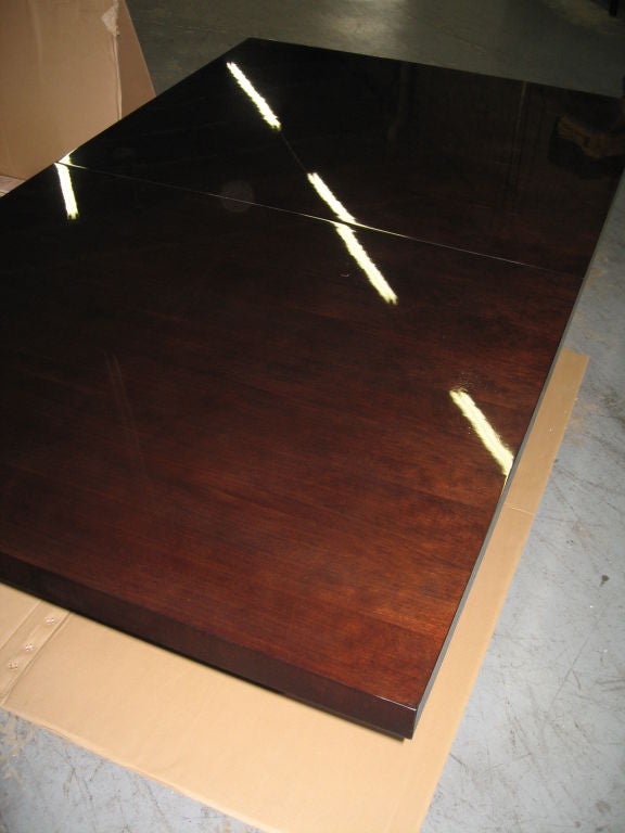 Superb Calvin Klein dining table, purchased and never used by original owner, still in the original box.  One leaf included, which has a small corner nick, as shown in photo, otherwise in superb condition, ready to use. Extends to 104