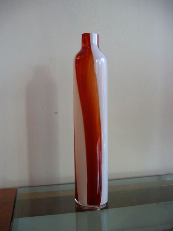 Tall slender Murano glass vase with a red and white candy stripe pattern. Elegant and attractive.
