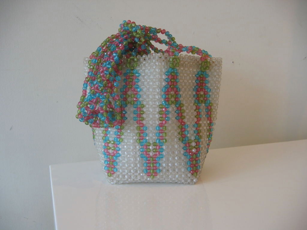This spring / summer vintage Italian handbag by Coppola e Toppo is in multi colored beaded design with circular sliding handle closure. Wonderful colors of turquoise, chartreuse, hot pink, in plastic beaded form. Clean mint condition. It is from the