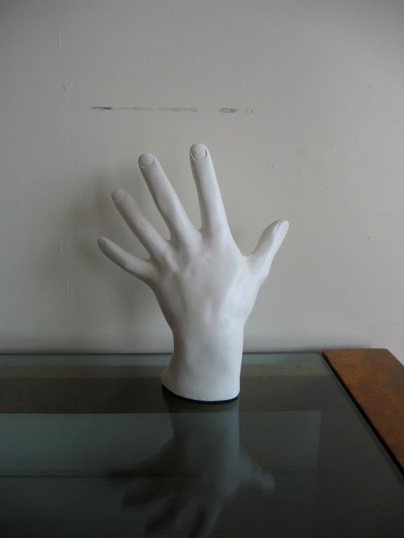 Intriguing big hand sculpture fashioned from plaster. Very real with veins and fingernails. Shown in standing position but can be mounted to a wall or used resting on a table top. Markings of copy write and date near wrist. Another hand is always