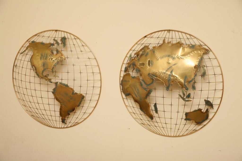 Exquisitely executed convex open grid wall sculptures as hemispheres fashioned of brass with scorching and oxidation. Signed and dated. Sold as a pair. Excellent way to bring the world into your home and placed on your wall.