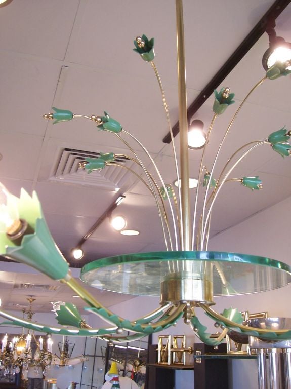 This six (6) light chandelier has a beautiful glass disc center from which the lights and flower buds emanate.