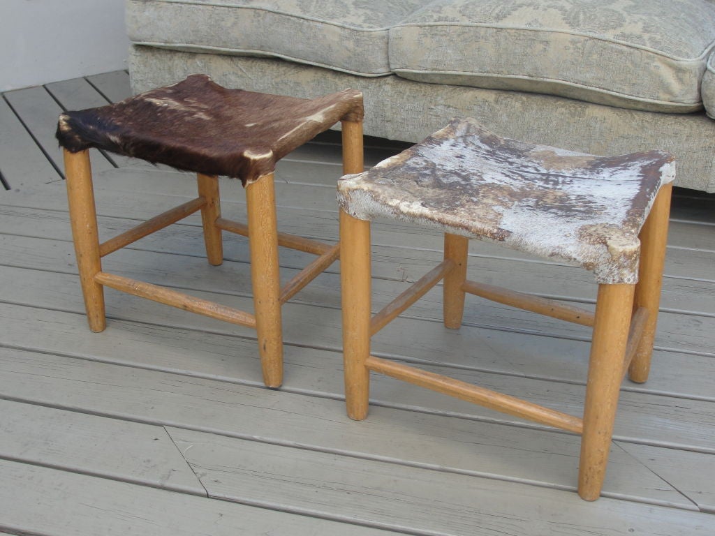 Aged cowhide seats and oak frame, these stools are perfect for additional seating or accents.

