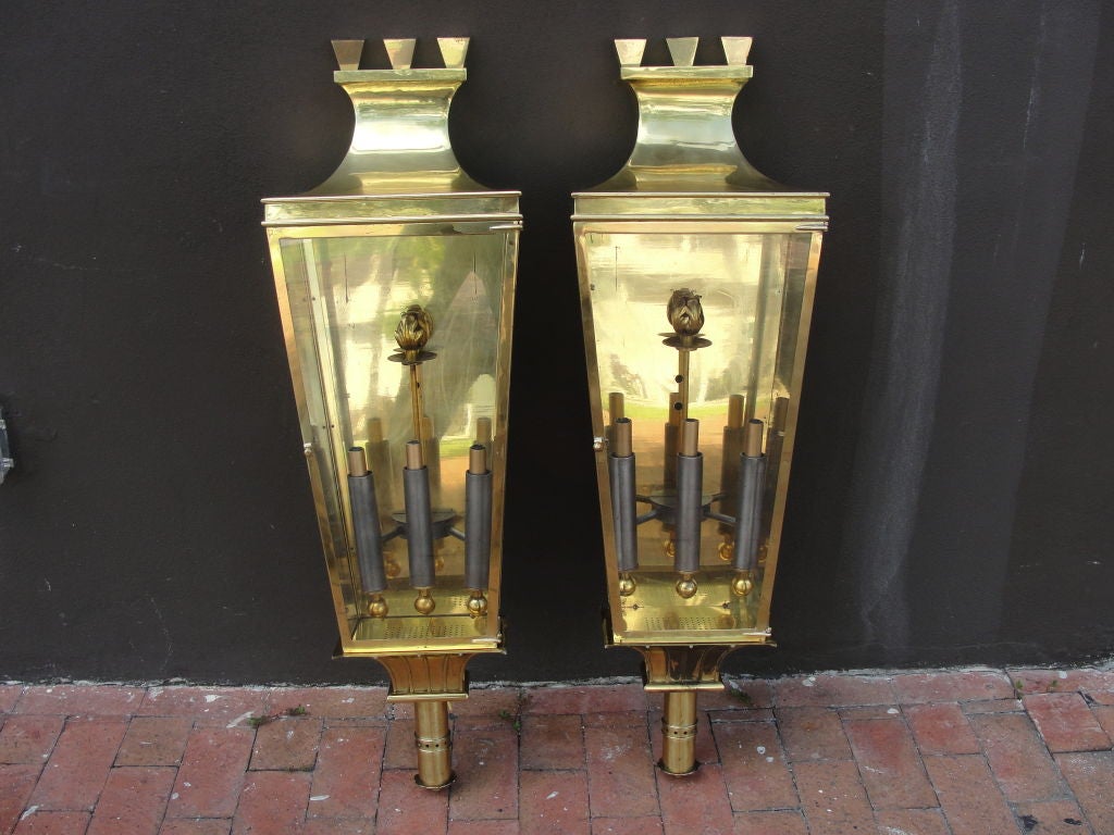 A total of four available, but priced in pairs. These wonderfully Classic brass wall sconces with crown tops and glass opening doors with incredible hinges and details throughout and a beautiful patina.