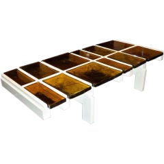 A Modernist Cocktail Table in White Lacquer and Amber Glass A Modernist Cocktail Table in White Lacquer and Amber Glass