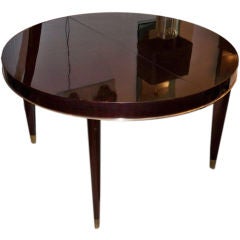 A Round Extending Dining Table in Mahogany by Josef DeCoene
