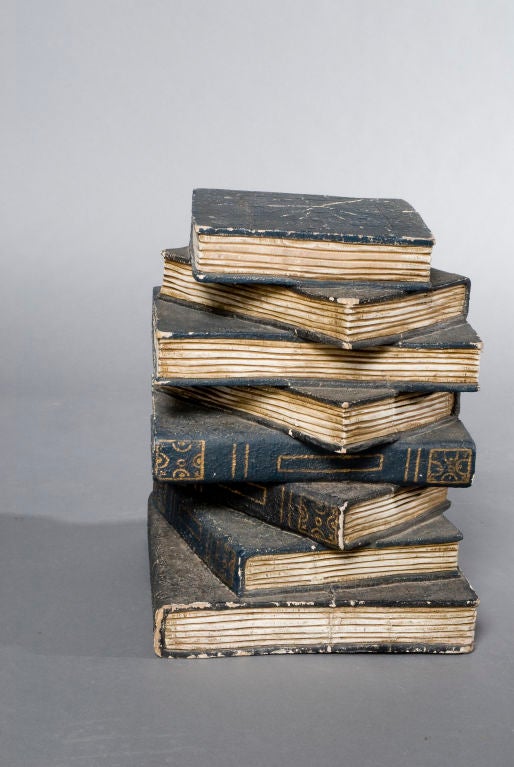 Stack of eight attached French faux books to be used as side table. Located in dealers warehouse.