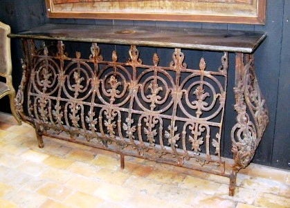 Iron console table with a Belgian bluestone top. The table is made from an old balcony. Note the intricate design details. The top is vintage bluestone.