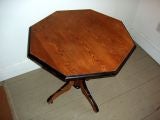 19th century octagonal side table in the style of Charles X. The legs are on casters for easy movement. Ebony accents. Would also make a great small dining table.