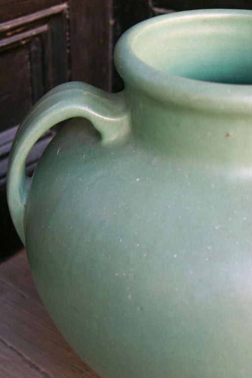 Double Handled Green Glazed Urn from a OHIO Pottery Manufacturer. Probably made in Zanesville Ohio in the 1930's or 1940's.  A Delicate Handled Form with a Wonderfully Colored Matte Green Glaze in Excellent Condition