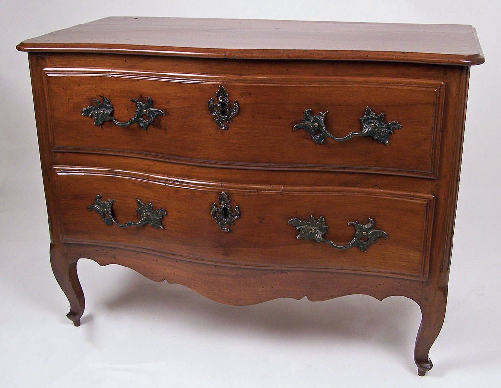 Louis XV Style Serpentine Shape Two Drawer Chest with iron pull and escutcheons standing on cabriole legs ending in curled feet.  French, Circa 1830.
