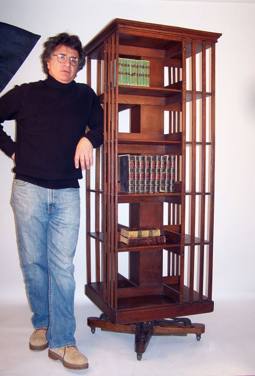An unusually tall revolving bookcase.