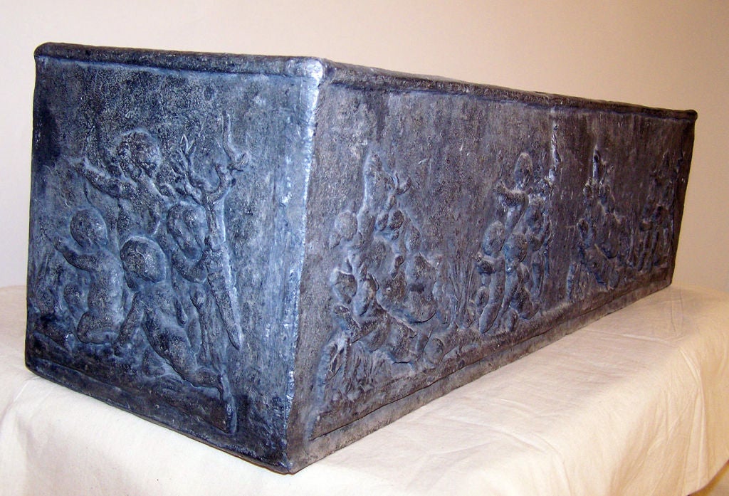 Old lead planter with raised putti design.