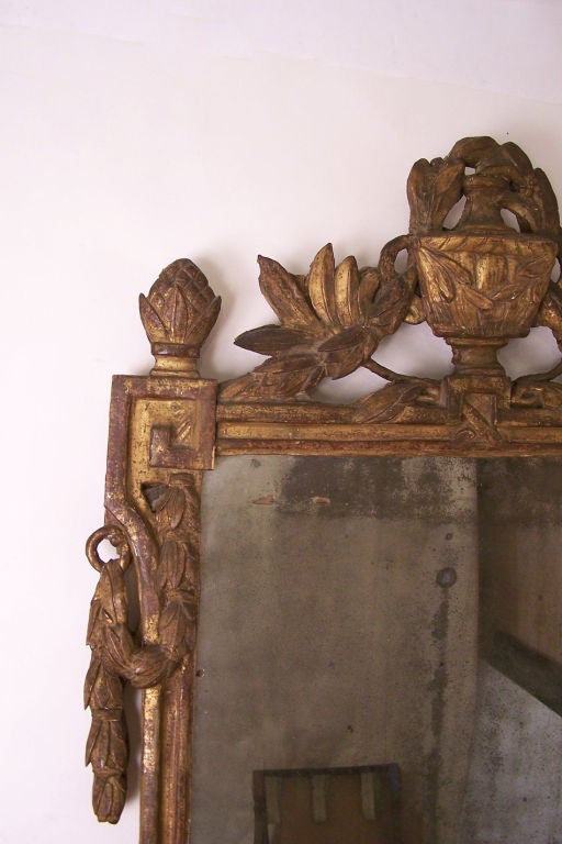 Merveilleux miroir à encadrement en bois sculpté et doré.  Typiquement Louis XVI avec les traditionnelles feuilles de laurier, branches et urnes sculptées.  Avec sa plaque de miroir d'origine et ses panneaux arrière sculptés.  Français, Circa 1860.
