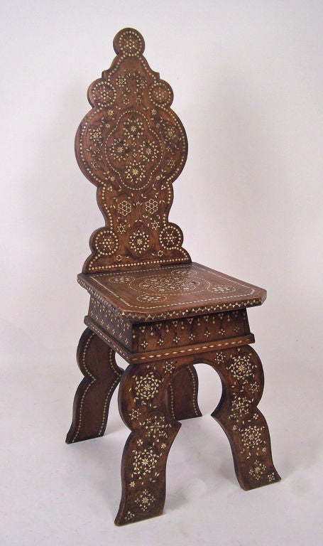 Walnut chair with detailed bone inlaid design.