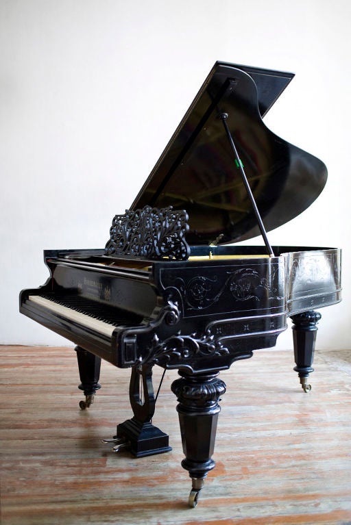 Very rare and imposing grand piano by Germany's oldest piano maker. Elaborate fretted music desk, carvings and neo romantic engravings on the cabinet.