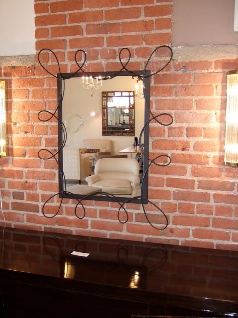 Pair of rectangular scrolled iron mirrors. Hand welded iron frame with a black matte powder coating. Can be hung vertical or horizontal. Custom sizes can be made. These mirrors can be sold as a single.