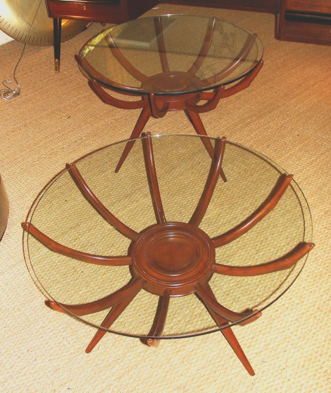 An exquisite table designed by Carlo De Carli, Renato Angeli and Luigi Claudio Olivieri. Stained beech wood structure with a contemporary glass top. Bibliography Aloi 1945 n 287. Slight differences in height, diameter and decoration of the round