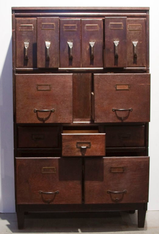 Unique filing cabinet from the 1920's. Modular! There are 6 separate levels (including top and base with legs) which can be interchanged to fit use and space needs. Original wood with beautiful color. Classic dove-tailing on every drawer. For home