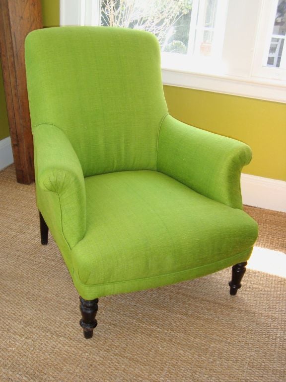 A Napoleon III club chair reupholstered in lime colored raw silk.