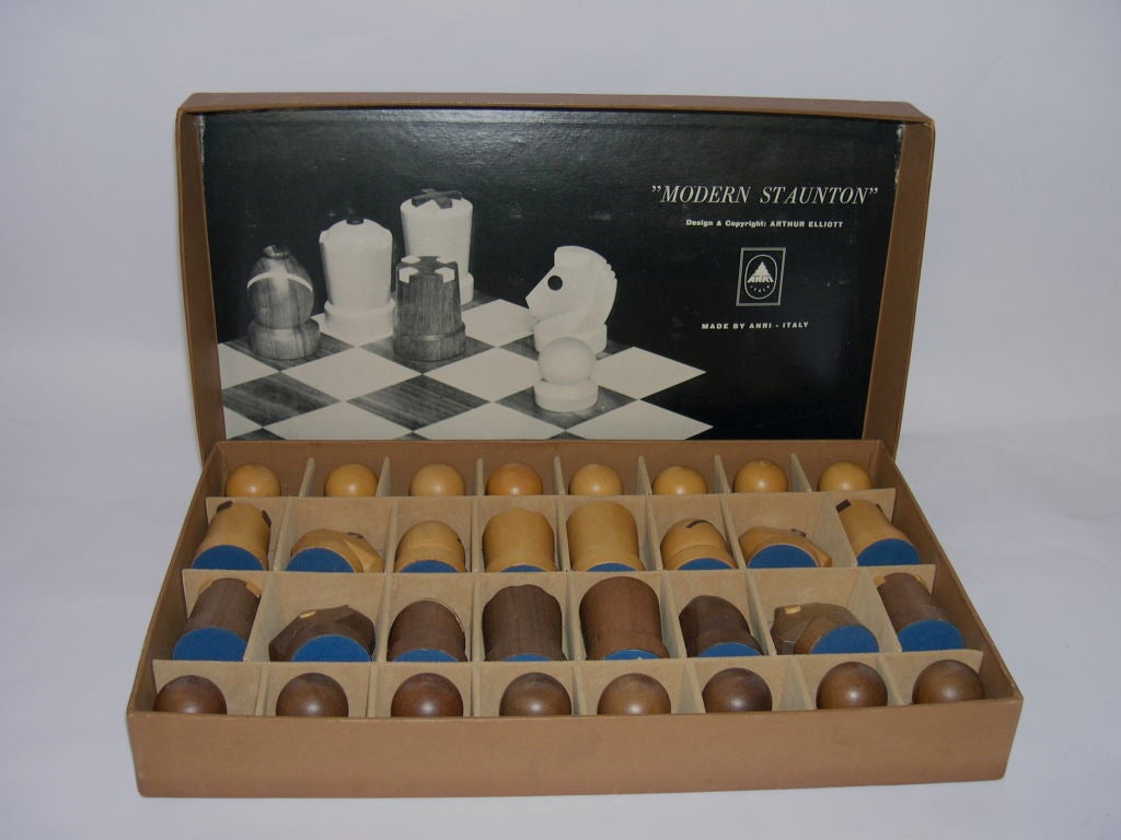 This is a wonderful modern chess set designed by Arthur Elliott for Arni, Italy. Crafted in walnut and maple, it comes with it's original box and inlaid board. The board and many of the pieces still retain their original labels. The board is 14