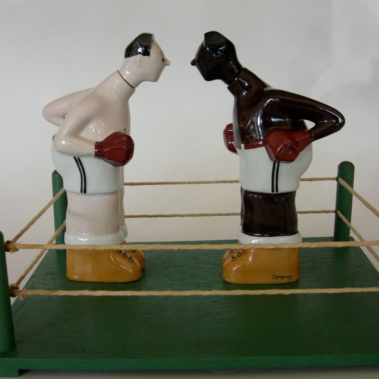 These wonderful porcelain decanters were designed by E. Margerie and manufactured by Georges Bastard. It is extremely rare to find these decanters as pair, especially with the original display stand. They are fabulous. The wood display ring measures