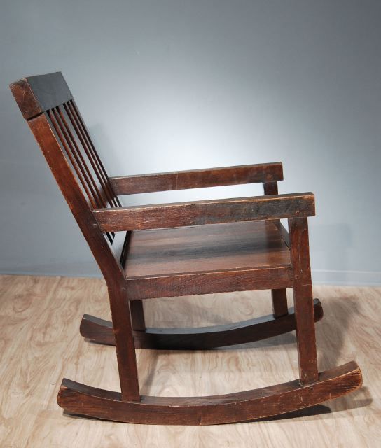 A French  Stained Oak Arts and Crafts Rocking Chair  with  a Slatted Back and an Exceptionally Wide Seat. Circa 1900-1910