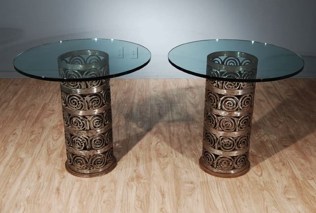A Pair of Gueridons with Glass Tops and Handsome Forged Steel Pedestals Having Stylized Foliate Whorls in the Manner of Edgar Brandt. Circa 1930