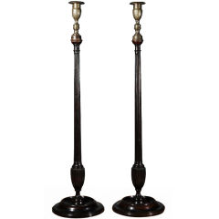 A Pair of Belgian Mahogany and Brass Tall Candlesticks