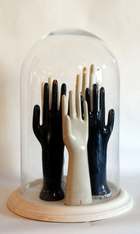 Old factory glove mold collection in a vintage dome
